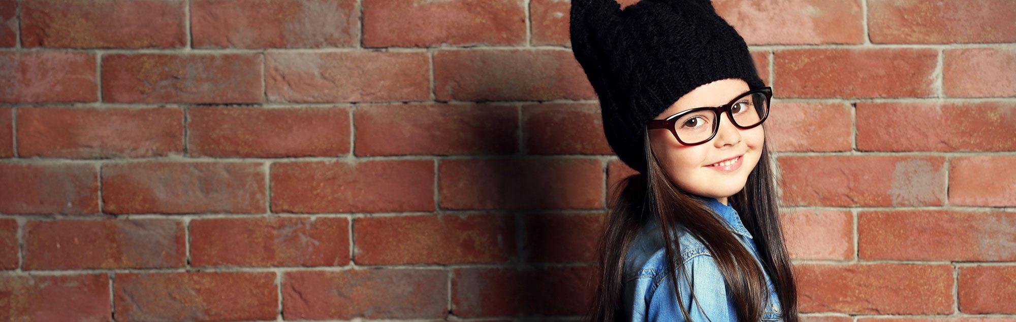 little girl wearing black hat